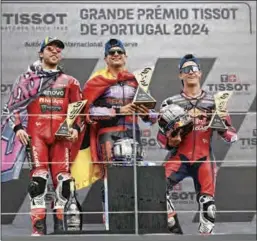  ?? ?? Ducati Spanish rider Jorge Martin (C), second placed Ducati Italian rider Enea Bastianini (L) and third placed teeanage rookie KTM Spanish rider Pedro Acosta with their trophies at the Portuguese Grand Prix at the Portimao Circuit in Algarve on Sunday.