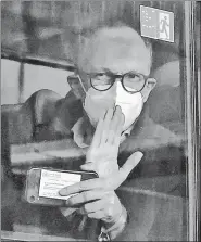  ?? REUTERS ?? Peter Ben Embarek, a member of the WHO’s probe team, waves from a bus while leaving the Wuhan Tianhe Internatio­nal Airport in Wuhan, China, on Thursday.