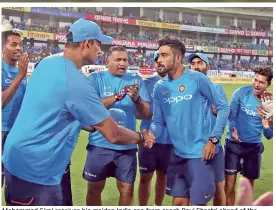  ?? — BCCI ?? Mohammed Siraj receives his maiden India cap from coach Ravi Shastri ahead of the second T20 at Rajkot on Saturday.