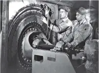  ?? FILE PHOTO BY ED WESTCOTT/DEPARTMENT OF ENERGY ?? Workers perform maintenanc­e at K-25, the production facitily at the Clinton Engineer Works in Oak Ridge, Tenn. When built in 1944, it was the largest building in the world with 1.64 million square feet of floor space.