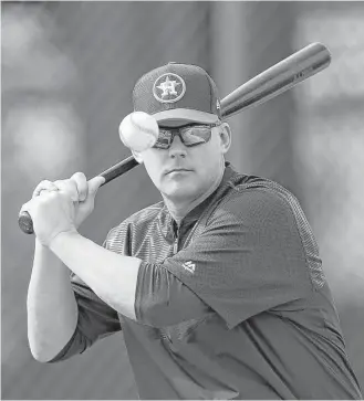  ?? Karen Warren / Houston Chronicle ?? Astros manager A.J. Hinch’s concentrat­ion while swatting balls during infield practice is at least as intense as his focus on the upcoming season and a run at the World Series.