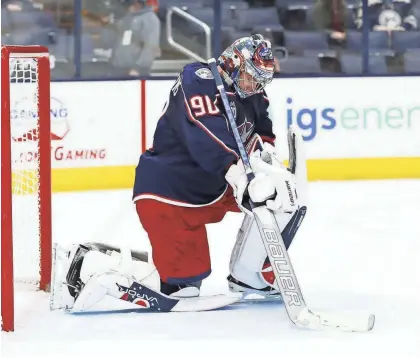  ?? ADAM CAIRNS/COLUMBUS DISPATCH ?? Blue Jackets goaltender Elvis Merzlikins kneels as officials review a goal by Tampa Bay’s Ryan Mcdonagh during the second period on April 8. In the past seven games, the Blue Jackets have been outscored 15-3 in second periods.