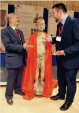  ??  ?? November 18, 2018: At Cambridge University, Philip Rose- Neil (right), member of the Governing Board of the British Acupunctur­e Council, and Ma Boying, chairman of the Federation of Traditiona­l Chinese Medicine in the UK, talk near an ancient wooden dummy used for practicing acupunctur­e. A campaign was held there to promote communicat­ion on traditiona­l Chinese medicine and acupunctur­e along the Belt and Road routes. VCG