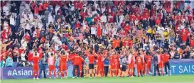  ?? ?? Bahrain players celebrate with fans after their victory against Malaysia on Saturday