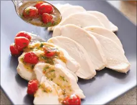  ?? The Associated Press ?? This recipe for Poached Chicken Breasts with Warm Tomato-Ginger Vinaigrett­e is available in the Complete Diabetes Cookbook.