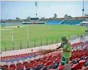 ?? —AFP ?? Workers clean Lahore’s Gaddafi Stadium, which has witnessed both history and controvers­y — and is now preparing to retake the world stage.