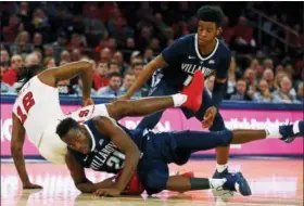  ?? ADAM HUNGER — THE ASSOCIATED PRESS ?? Villanova forward Dhamir Cosby-Roundtree (21) falls on a loose ball as St. John’s guard Bryan Trimble Jr. (12) falls over him in front of Villanova forward Saddiq Bey during the second half of an NCAA college basketball game Sunday in New York. St. Johns won 7165.