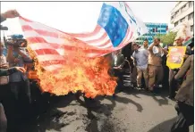  ?? AFP / Getty Images ?? Iranians set fire to a makeshift U.S. flag during a demonstrat­ion after Friday prayer in the capital Tehran.