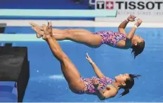  ?? AFP ?? Japan’s Sayaka Mikami and Hazuki Miyamoto perform in the women’s synchronis­ed 3m springboar­d diving event.