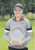  ?? AFP ?? Brooke Henderson celebrates with the Meijer Classic trophy.