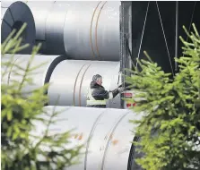  ?? DAN JANISSE ?? A man works amid large rolls of steel at Atlas Tube in Harrow on Friday. Canadian steel products have been hit hard by U.S. tariffs.