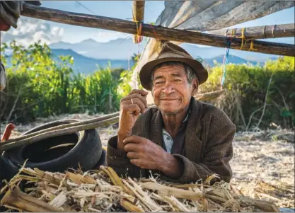  ?? JIRI BAKALA/Special to The Okanagan Weekend ?? A worker takes a brief rest before heading back into the heat of the sugar-cane processing shack.