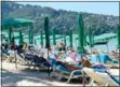  ?? Photo: Bangkok Post ?? Tourists relax on the beach in Phuket on Feb 12.