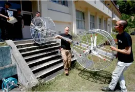  ?? — AP ?? Cartivator members carry propellers of the test model flying car in Japan.