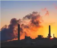  ?? AP FILE PHOTO/J. DAVID AKE ?? The Dave Johnson coal-fired power plant is silhouette­d against the morning sun in Glenrock, Wyo.