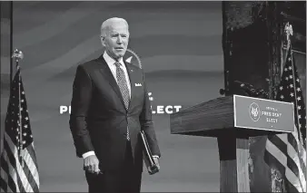  ??  ?? President-elect Joe Biden pauses as he leaves to listen to a reporter's shouted question, Tuesday at The Queen Theater in Wilmington, Del. [CAROLYN KASTER/ THE ASSOCIATED PRESS]