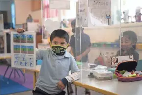  ?? AP ?? Cesar Verdugo, 5, shows off his work at West Orange Elementary in Orange, Calif. With a massive infusion of federal aid coming their way, schools across the U.S. are weighing how to use the windfall to ease the harm of the pandemic.