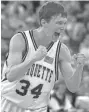  ??  ?? Marquette guard Travis Diener reacts after sinking a free throw that sealed the win over Holy Cross.