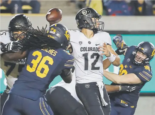  ?? Jeff Chiu, The Associated Press ?? Colorado quarterbac­k Steven Montez passes under pressure against California during the second half on Saturday night. Montez threw two touchdowns, but had three intercepti­ons in the Buff ’s 33-21 loss to cap a dismal 5-7 season.