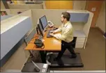  ?? MICHAEL CONROY/AP PHOTO ?? Josh Baldonado, an administra­tive assistant at Brown & Brown Insurance in Indiana, works at a treadmill desk on Aug. 28.