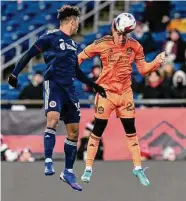  ?? Andrew Katsampes/ISI Photos ?? New England’s Brandon Bye, right, and the Dynamo’s Tate Schmitt battle for the ball on Saturday.