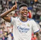  ?? Shaun Botterill / Getty Images ?? Vinicius Junior of Real Madrid celebrates after scoring in the 59th minute Saturday against Liverpool.