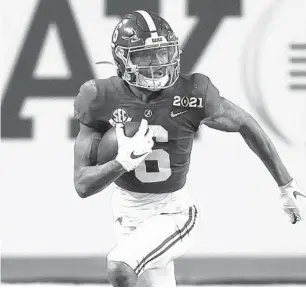  ?? SAM GREENWOOD/GETTY ?? DeVonta Smith of the Alabama Crimson Tide runs for yardage during the CFP National Championsh­ip Presented by AT&T at Hard Rock Stadium on Jan. 11 in Miami Gardens, Florida.