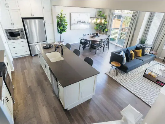  ?? PHOTOS: MORRISON HOMES ?? Kitchen, dining area and great room can be seen in this view of the open-concept main level in the Montgomery show home by Morrison Homes in Symons Gate.