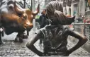  ?? BEBETO MATTHEWS/AP ?? The “Fearless Girl” statue across from the “Charging Bull” on Wall Street will be allowed to remain through February.