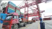  ?? SI WEI AND ZHANG JINGANG / FOR CHINA DAILY ?? Top: Workers make stuffed toys, which will be exported to Europe and the United States, at a factory in Lianyungan­g, Jiangsu province. Above: Goods are loaded onto a container ship for export in Qingdao, Shandong province.