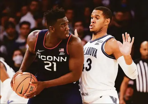  ?? Tim Nwachukwu / Getty Images ?? UConn's Adama Sanogo (21) could be going up against Villanova's Eric Dixon three times in the regular season alone in 2022-23.
