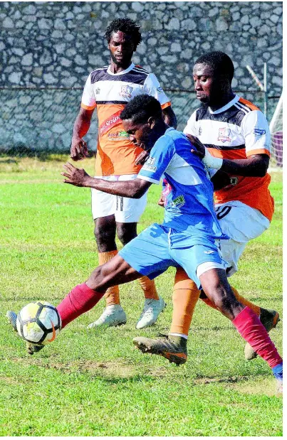  ?? PHOTOGRAPH­ER LIONEL ROOKWOOD/ ?? Portmore United’s goalscorer Lamar Walker fends off a challenge from Dunbeholde­n’s Richard Anderson during their Red Stripe Premier League encounter at the Spanish Town Prison Oval on Tuesday, March 19. Portmore United won the match 2-0.