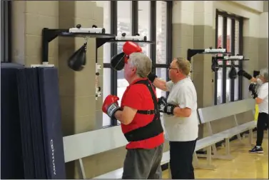  ?? The Sentinel-Record/Tanner Newton ?? FIGHTING PARKINSON’S: A Rock Steady Boxing fighter attacks a speed bag recently at First Baptist Church. The workout is designed to help people cope with the symptoms of Parkinson’s disease.