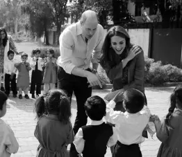  ?? AP ?? Britain’s Prince William and his wife Kate interact with students during their visit to a school outside Islamabad, Pakistan, yesterday.