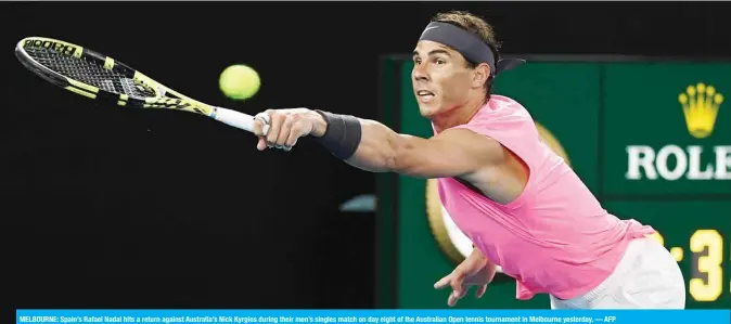  ??  ?? MELBOURNE: Spain’s Rafael Nadal hits a return against Australia’s Nick Kyrgios during their men’s singles match on day eight of the Australian Open tennis tournament in Melbourne yesterday. — AFP