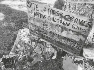  ?? SUSAN MONTOYA BRYAN/AP ?? A MAKESHIFT MEMORIAL for the dozens of Indigenous children who died more than a century ago while attending a boarding school that was once located nearby is displayed under a tree at a public park in Albuquerqu­e, N.M., on July 1, 2021.