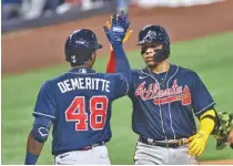  ?? AP PHOTO/GASTON DE CARDENAS ?? The Atlanta Braves’ William Contreras celebrates with second baseman Travis Demeritte after hitting a solo home run during the fifth inning against the host Miami Marlins on Saturday.