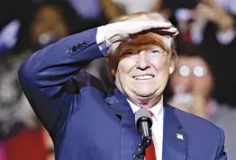  ?? Associated Press ?? n President-elect Donald Trump shades his eyes Tuesday while looking at supporters during a rally in Fayettevil­le, N.C.