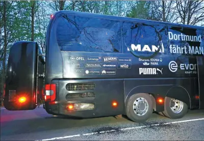  ?? REUTERS / KAI PFAFFENBAC­H ?? Borussia Dortmund’s team bus shows damage caused by three roadside explosions as the German squad traveled to its Champoins League quarterfin­al with Monaco in Dortmund on Tuesday. The first-leg match was postponed.