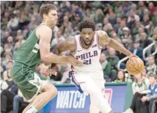  ?? — USA Today Sports ?? Philadelph­ia 76ers’ Joel Embiid (21) drives for the basket against Milwaukee Bucks’ Brook Lopez (11) at Fiserv Forum.