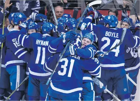  ?? TYLER ANDERSON ?? The Toronto Maple Leafs celebrate their overtime win against the Washington Capitals in Game 3 of their first-round playoff series in Toronto on Monday. The Maple Leafs won 4-3 after centre Tyler Bozak scored a minute and a half into overtime, and now...