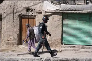  ?? The Associated Press ?? KABUL: An Afghan security officer arrives at an area near a house where attackers are hiding on Tuesday in Kabul, Afghanista­n. Talks next month in Moscow to discuss a peaceful end to 17 years of war in Afghanista­n that includes a place at the table for the Taliban has ruffled feathers in Washington and Kabul, who are refusing to attend, and resurrecte­d Cold War memories.