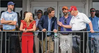  ?? Doug Mills/New York Times ?? Eric Trump, from left, Rep. Marjorie Taylor Greene, Tucker Carlson and Donald Trump Jr. visit with former President Donald Trump at Trump National Golf Club in Bedminster, N.J., in July.