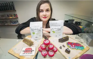  ?? — ARLEN REDEKOP ?? Buddha Barn Medical Cannabis manager Lindsay Bell displays some of the products the store is selling off to ensure it complies with new sourcing rules.