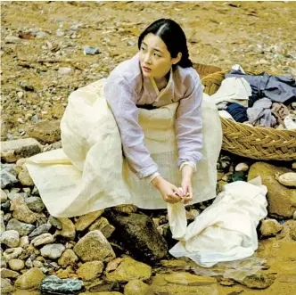  ?? JUHAN NOH APPLE TV+ ?? The younger Sunja, played by Minha Kim, washes clothes in a river near her family’s home in the Apple TV+ series “Pachinko.” New episodes hit the streaming service on Fridays.