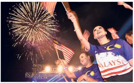  ??  ?? Merdeka spirit: People waving the national flag during the Fly the Jalur Gemilang 2018 campaign launch at the Esplanade in George Town.