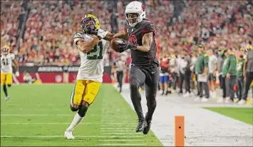  ?? Christian Petersen / Getty Images ?? Arizona’s Deandre Hopkins has a TD called back because of his penalty against Green Bay’s Eric Stokes. Arizona came up short on a late intercepti­on and suffered its first loss.