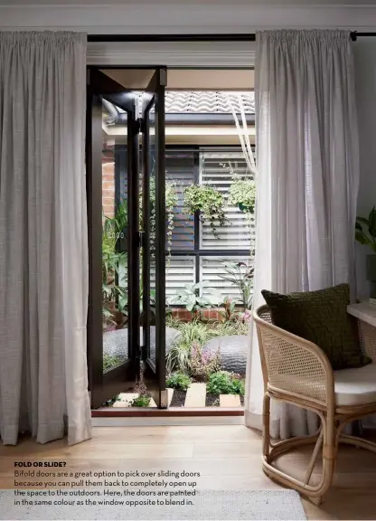  ??  ?? FOLD OR SLIDE?
Bifold doors are a great option to pick over sliding doors because you can pull them back to completely open up the space to the outdoors. Here, the doors are painted in the same colour as the window opposite to blend in.