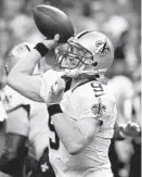  ?? BILL HABER/ASSOCIATED PRESS ?? Saints quarterbac­k Drew Brees took a hit to his throwing arm in Sunday’s 26-19 loss to the Buccaneers.