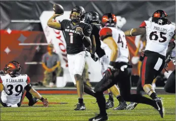  ?? Chase Stevens ?? UNLV quarterbac­k Armani Rogers, shown against San Diego State on Saturday at Sam Boyd Stadium, has thrown for 881 yards and five touchdowns this season.
Las Vegas Review-journal @csstevensp­hoto